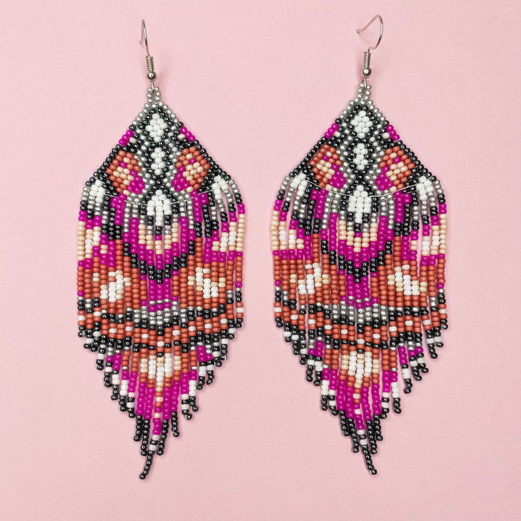 Beaded tassel earrings with pink, orange, and black pattern on a pink background - Beadzy