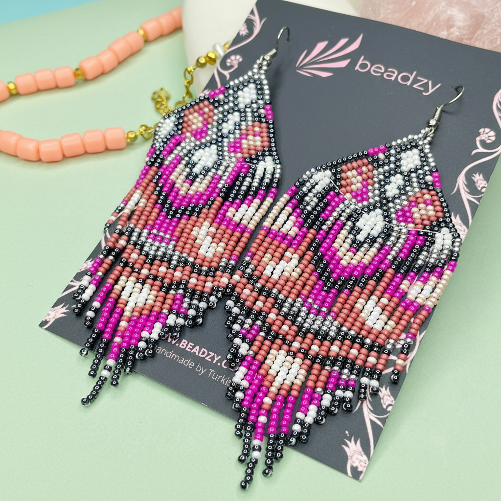 Purple beaded tassel earrings on a 'beadzy' branded card with a light green background - Beadzy
