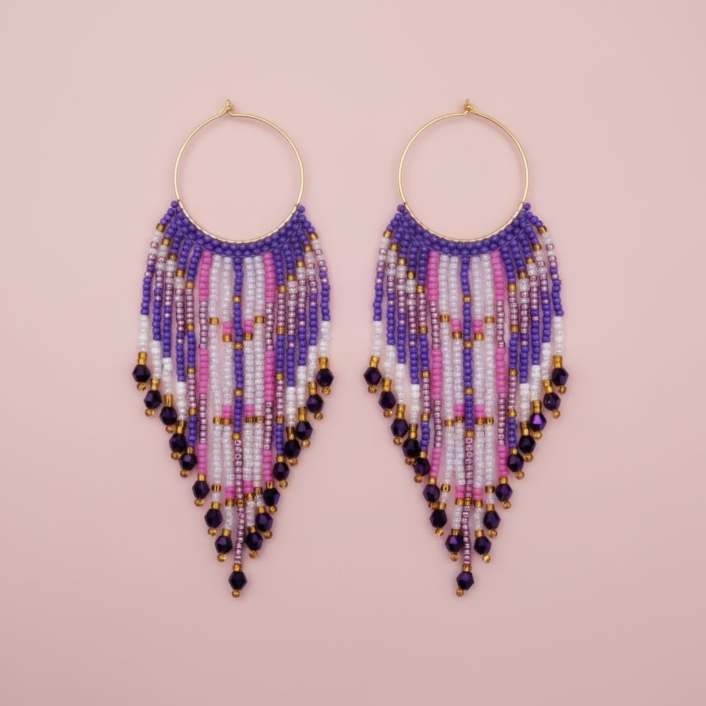 Beaded earrings with purple, pink, and gold accents on a pink background - Beadzy