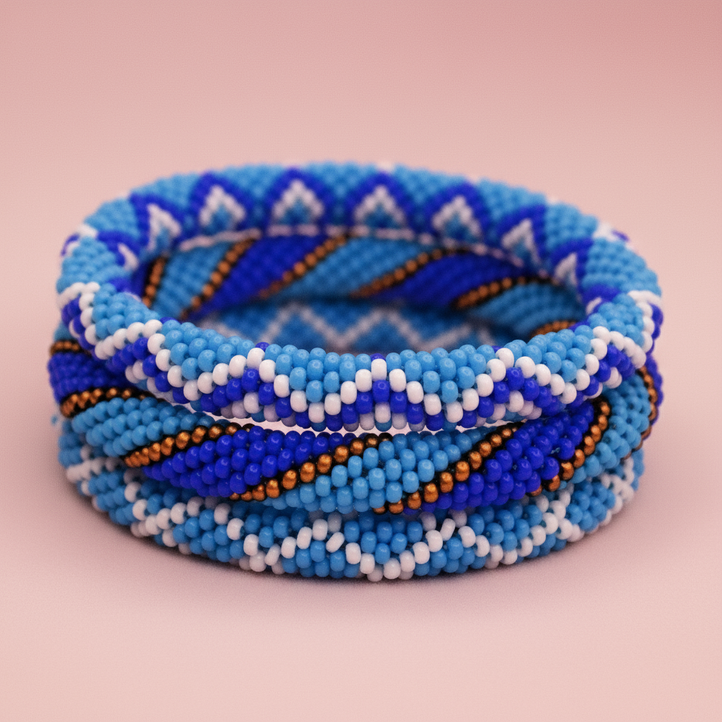Blue beaded bracelet with white, gold and blue patterns on a pink background - Beadzy
